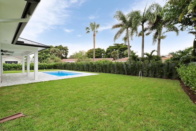 view of yard featuring a fenced in pool, a patio area, and ceiling fan