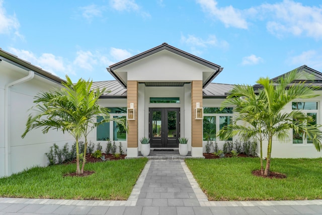 property entrance with a yard and french doors