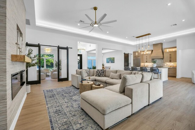 dining area with a tray ceiling, french doors, and hardwood / wood-style flooring