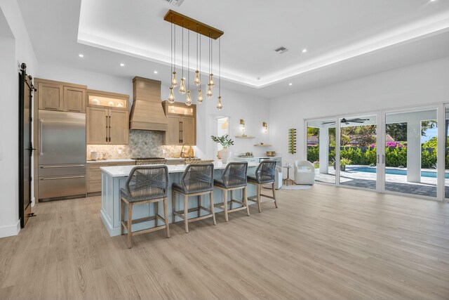 dining area with light parquet floors and a raised ceiling