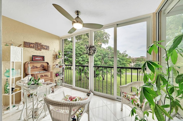 sunroom / solarium featuring ceiling fan