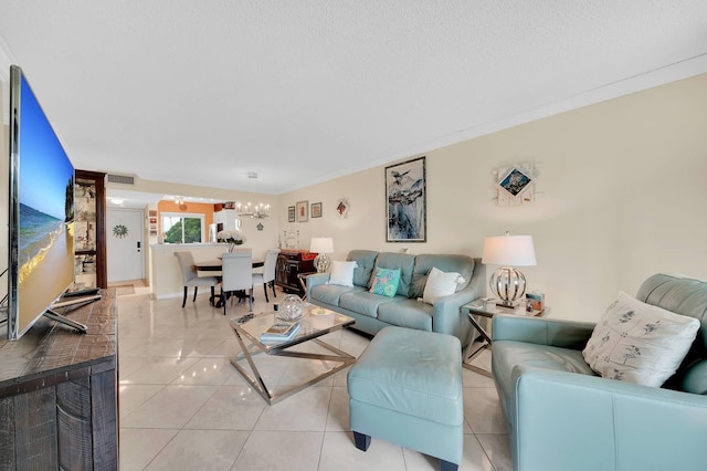 living room with a textured ceiling and light tile patterned flooring