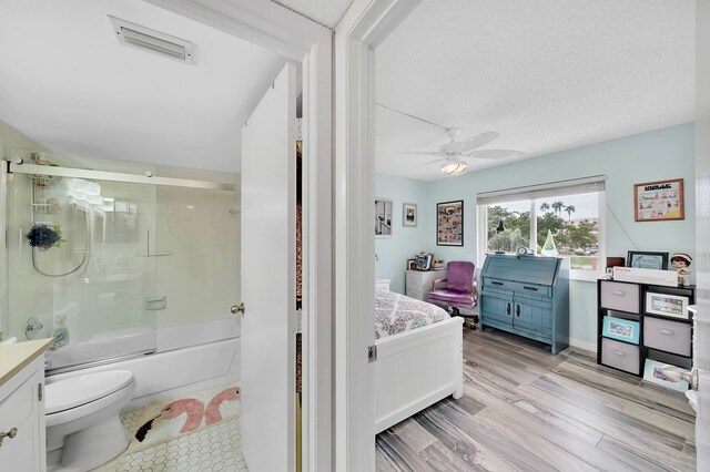 washroom with a textured ceiling, light tile patterned floors, and stacked washer and dryer