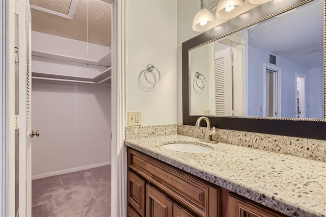 bathroom with vanity and a textured ceiling