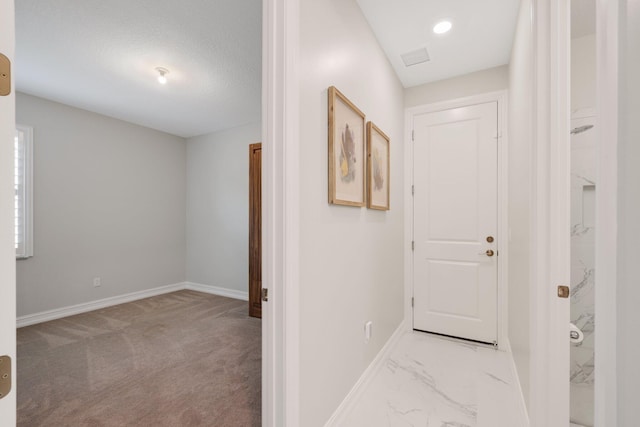 corridor featuring a textured ceiling