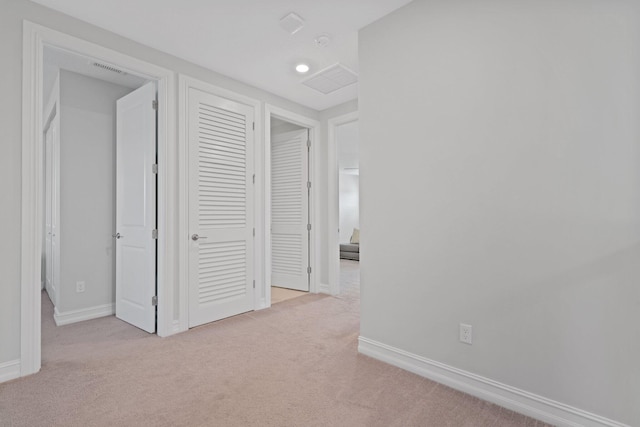 hallway with light colored carpet