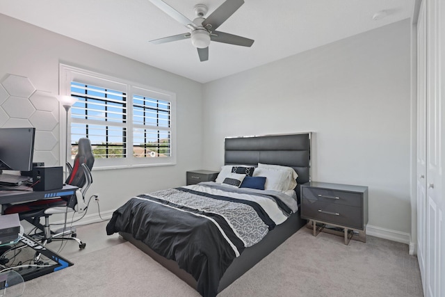 bedroom featuring ceiling fan, light colored carpet, and a closet