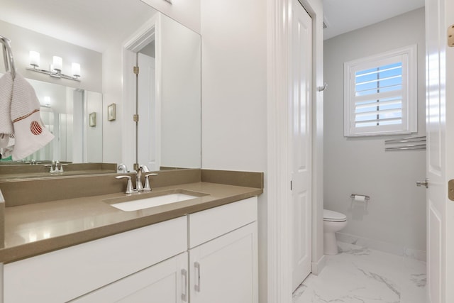 bathroom featuring vanity and toilet