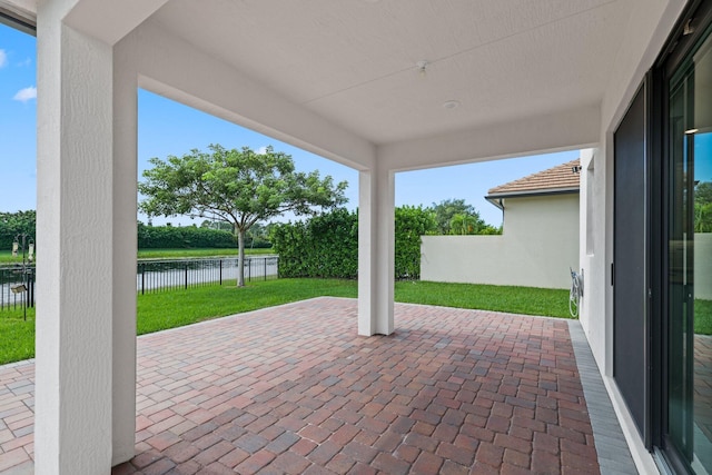 view of patio with a water view