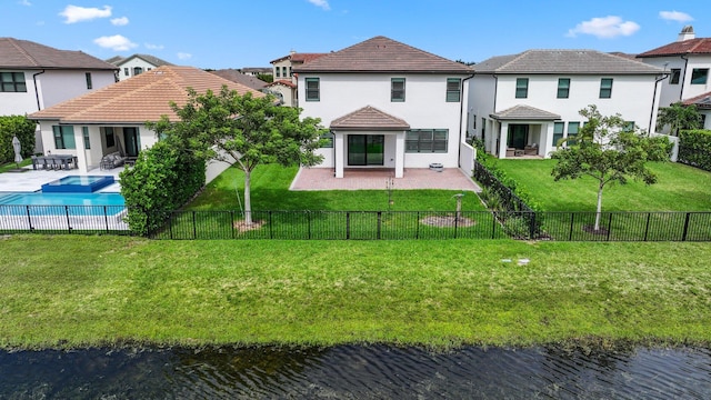 back of house featuring a fenced in pool, a patio area, a lawn, and a water view