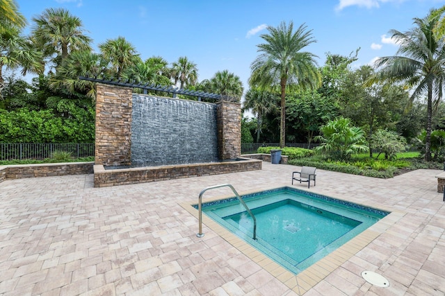 view of swimming pool featuring a patio area and an in ground hot tub