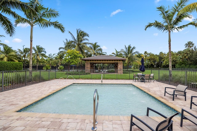 view of pool with a gazebo, pool water feature, and a patio area