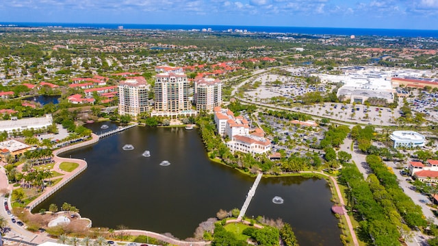 birds eye view of property with a city view and a water view