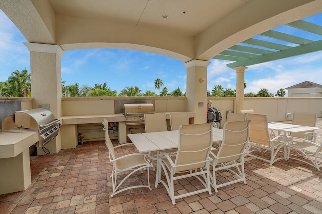 view of patio / terrace featuring an outdoor kitchen, a grill, and a pergola