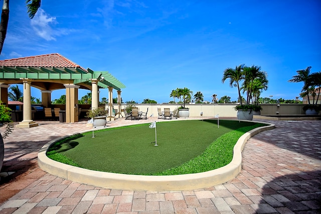 view of property's community featuring a pergola and a patio