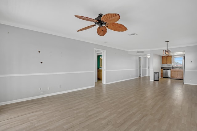 unfurnished living room with ornamental molding, ceiling fan, sink, and light hardwood / wood-style flooring