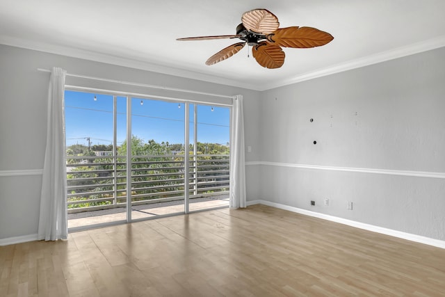 empty room featuring ornamental molding, ceiling fan, and hardwood / wood-style floors