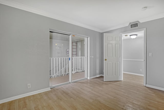 unfurnished bedroom featuring light hardwood / wood-style flooring and crown molding