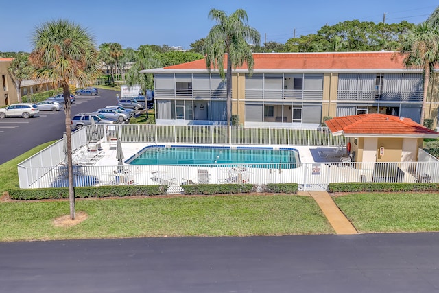 view of pool with a yard