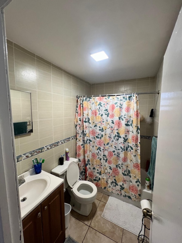 full bathroom with vanity, toilet, tile walls, tile patterned flooring, and shower / tub combo with curtain