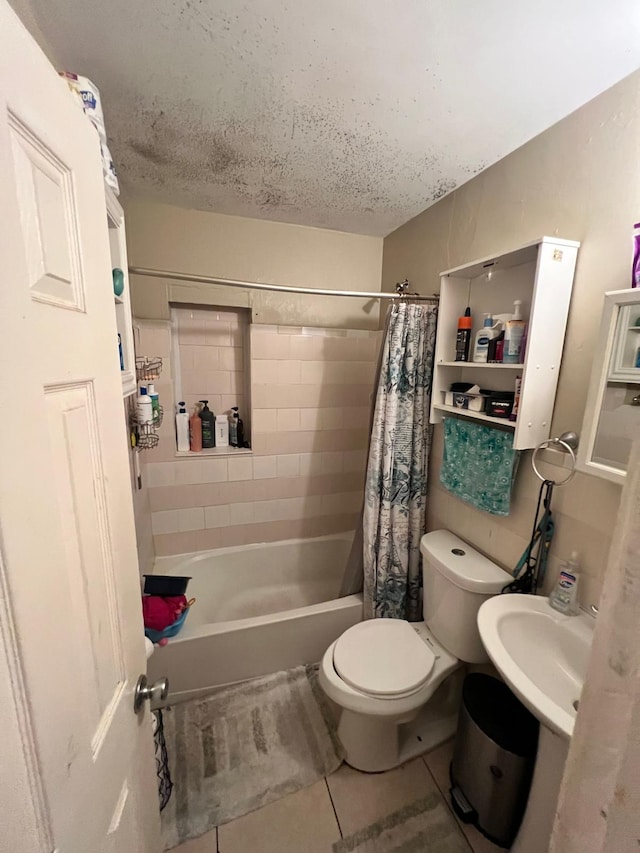 bathroom with a textured ceiling, shower / tub combo, toilet, and tile patterned floors