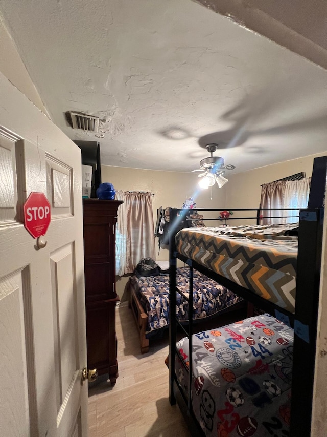 bedroom featuring ceiling fan and light hardwood / wood-style floors