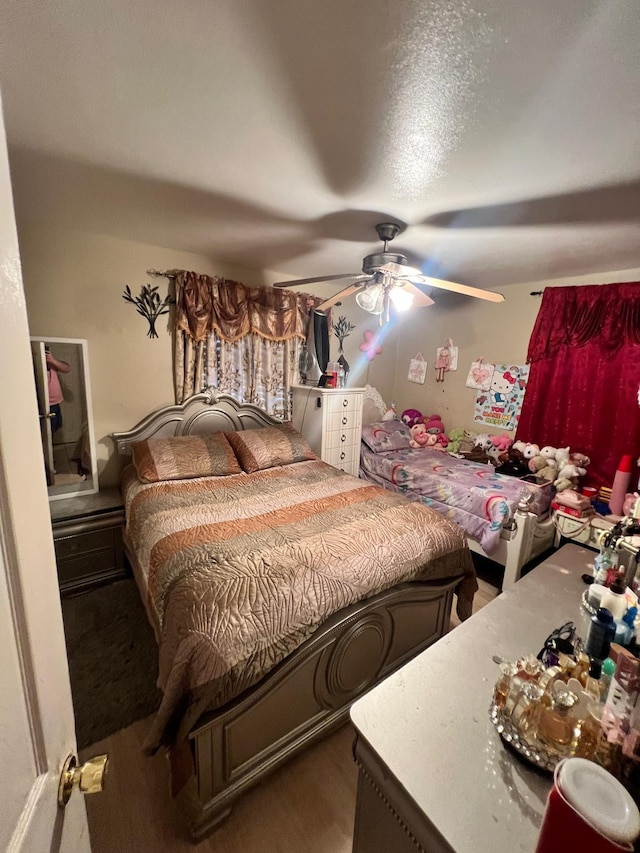 bedroom with dark colored carpet and ceiling fan