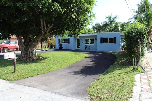 ranch-style home with a front lawn