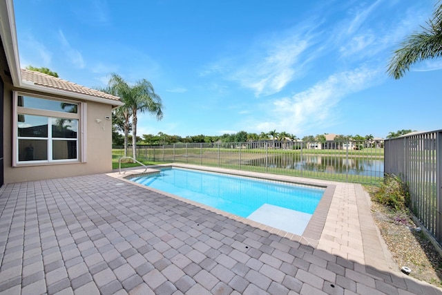 view of pool featuring a water view and a patio area