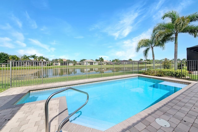 view of swimming pool featuring a water view