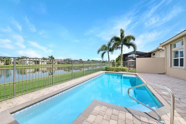 view of swimming pool with a patio and a water view