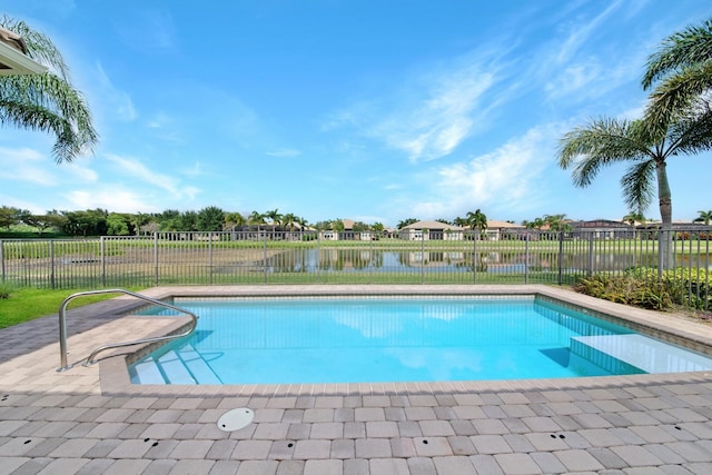 view of swimming pool featuring a water view