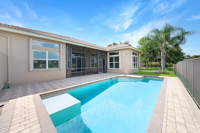 view of swimming pool featuring a sunroom and a patio area