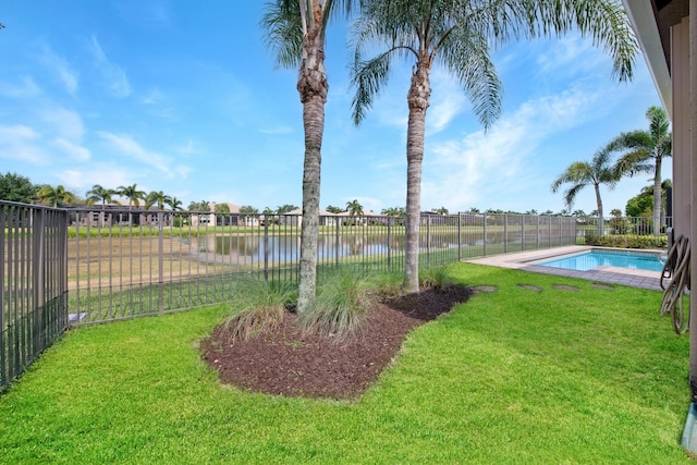 view of yard featuring a water view and a fenced in pool