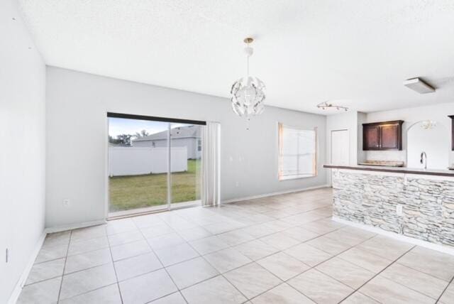 interior space featuring a chandelier and light tile patterned flooring