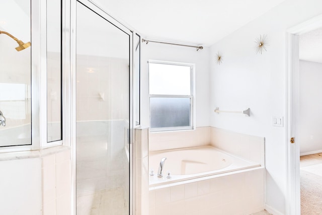 bathroom featuring shower with separate bathtub