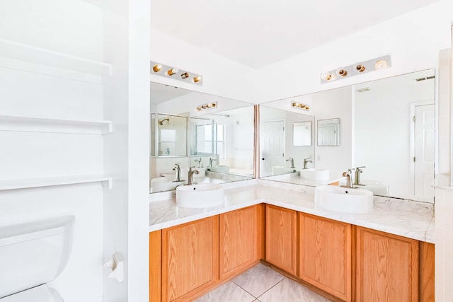 bathroom featuring vanity, toilet, and tile patterned floors