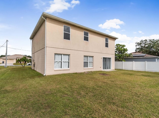 back of property with a lawn