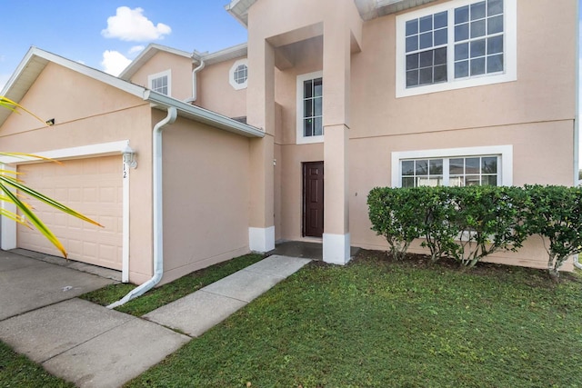 view of front of home featuring a garage and a front lawn