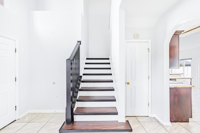 stairs with tile patterned floors