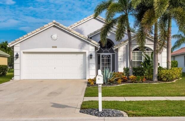 view of front of house with a front yard and a garage