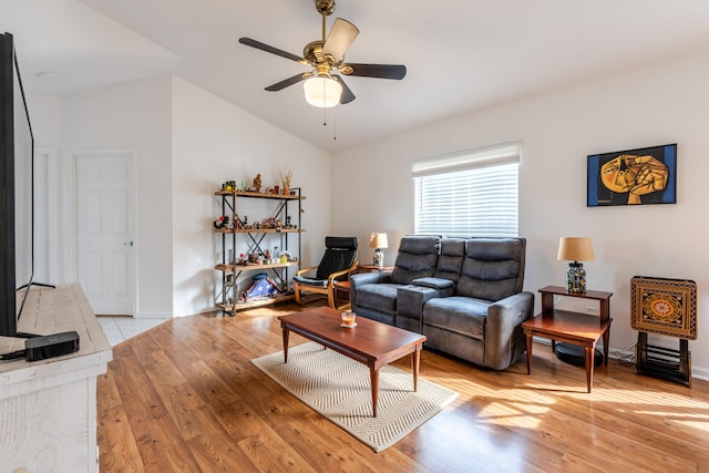 living room with vaulted ceiling, light hardwood / wood-style flooring, and ceiling fan