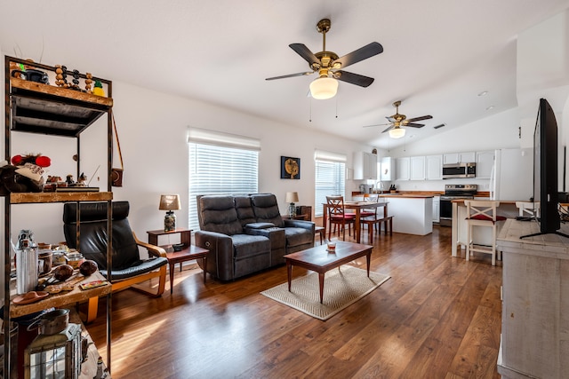 living room with ceiling fan, vaulted ceiling, and dark hardwood / wood-style floors