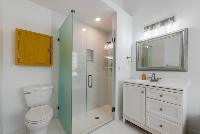 bathroom with vanity, a shower with shower door, toilet, and tile patterned floors