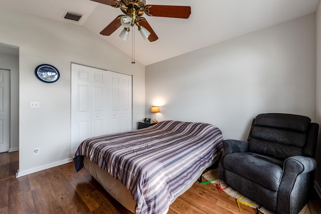 bedroom with vaulted ceiling, ceiling fan, a closet, and dark hardwood / wood-style flooring