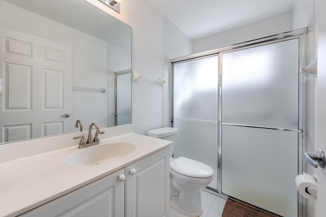 bathroom with vanity, toilet, walk in shower, and tile patterned flooring