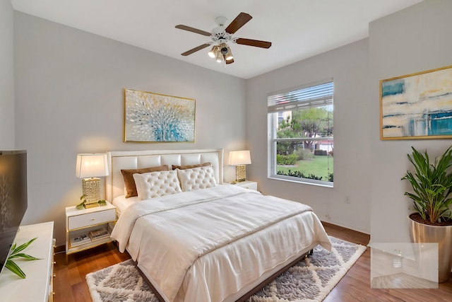 bedroom with ceiling fan and hardwood / wood-style floors