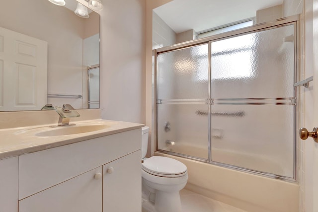 full bathroom featuring vanity, enclosed tub / shower combo, toilet, and tile patterned flooring