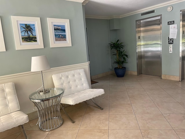 sitting room with light tile patterned floors, elevator, and ornamental molding