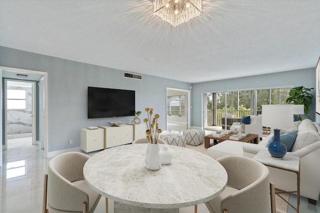 dining room with a textured ceiling, an inviting chandelier, and plenty of natural light